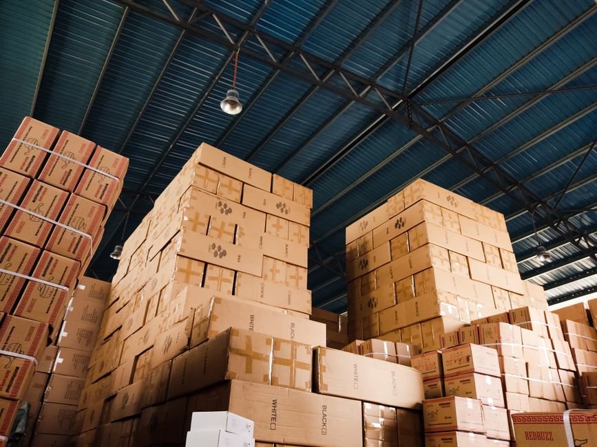 High stacks of corporate gift boxes organized in a warehouse for bulk ordering