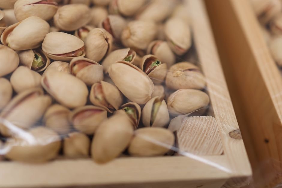 Unshelled pistachios in a wooden box for a plant based gift basket