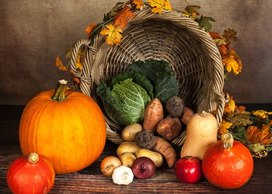 A rustic cornucopia overflowing with fresh autumn vegetables, symbolizing abundance