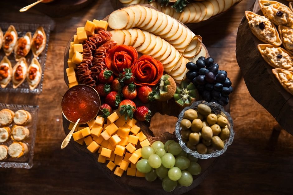 Elegant cheese and fruit platter on a wooden table