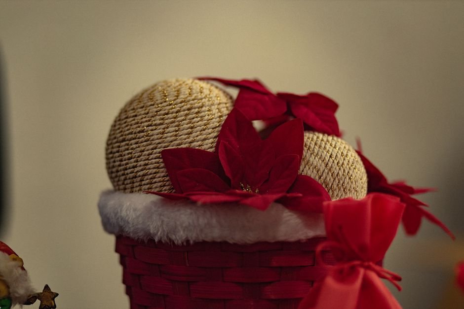Festive holiday gift basket decorated with red poinsettias