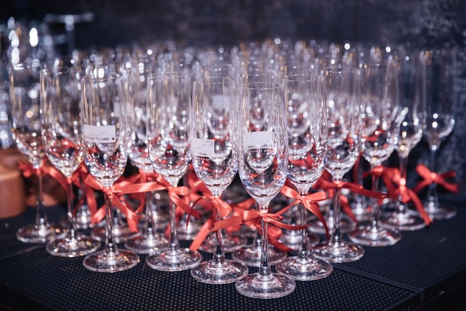 Champagne flutes decorated with ribbon for a celebratory gift basket toast