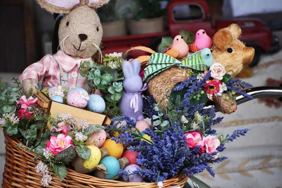 A fully assembled premade Easter basket with decorated eggs, flowers, and plush animals