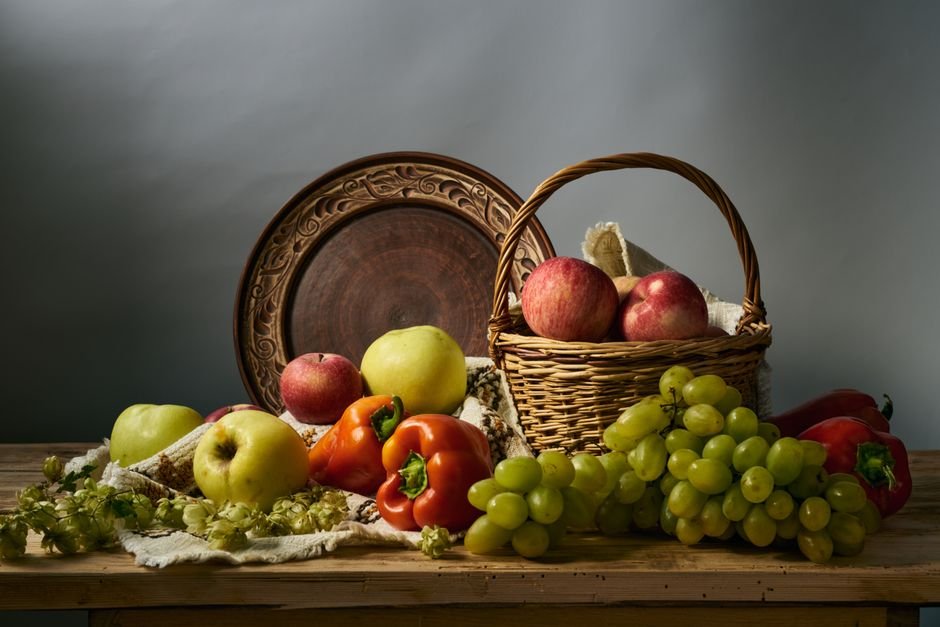 A rustic still life of fresh apples and grapes