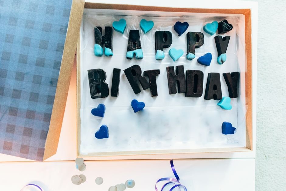 An open birthday box with Happy Birthday letters and personal touches inside