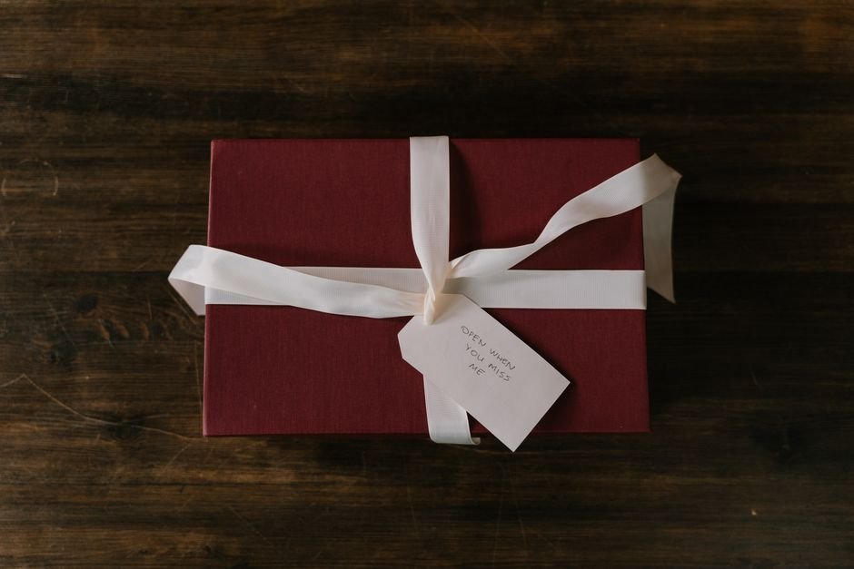 Gift box with ribbon and a handwritten tag