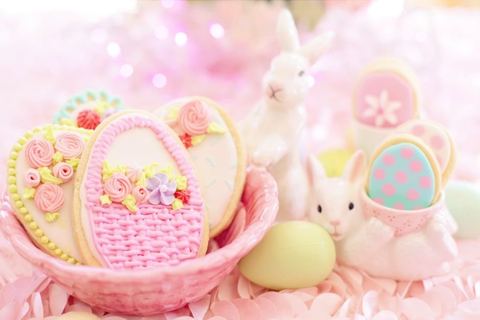 Elegant Easter cookies with pastel icing, part of a gourmet Easter basket spread