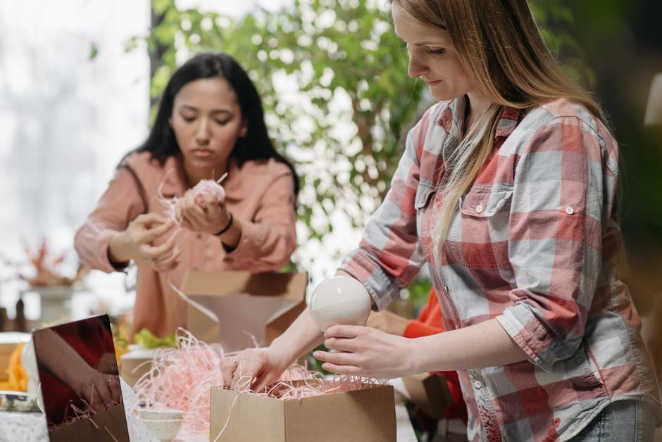Hands packing a gift basket order