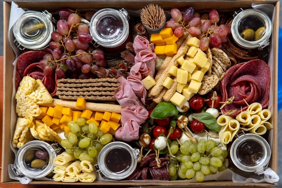 Close-up of a charcuterie gift basket showing the variety packed inside