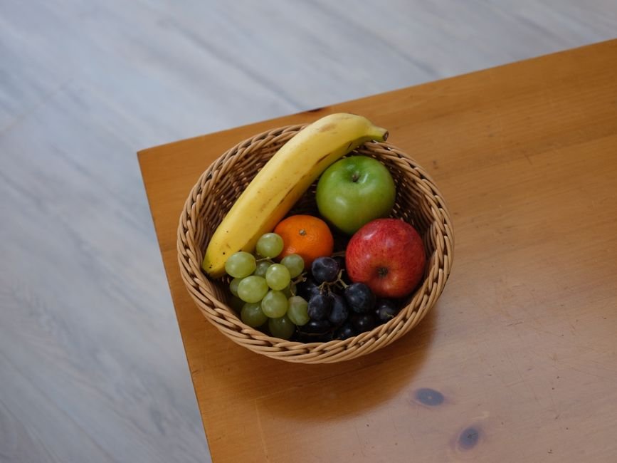 Wicker fruit gift hamper basket filled with fresh seasonal fruit