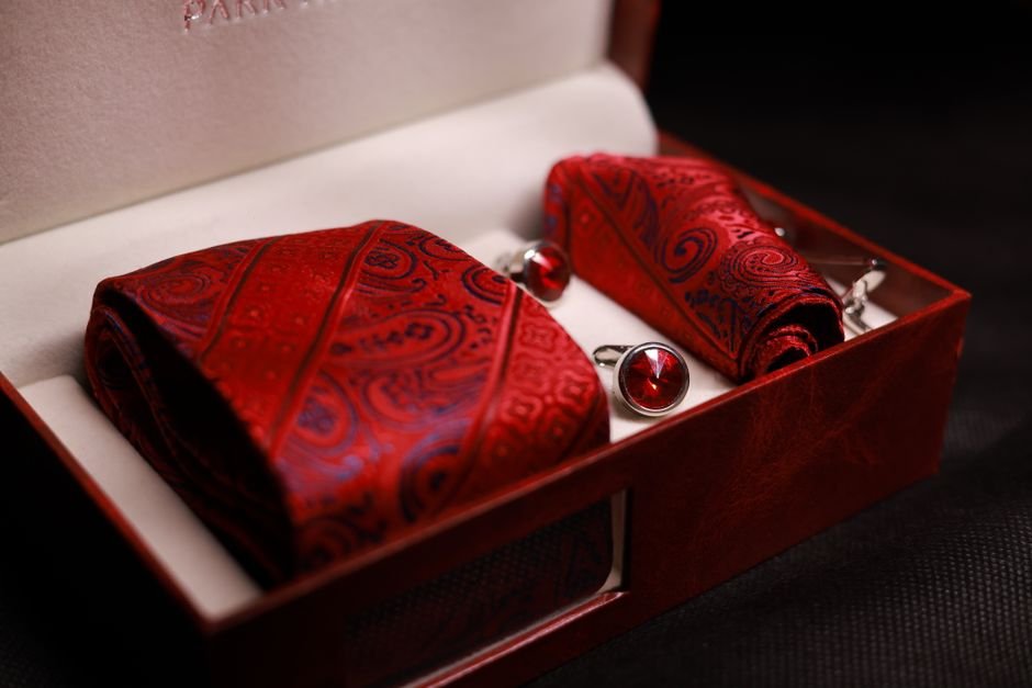 Silk necktie and cufflink gift set displayed in a box for men