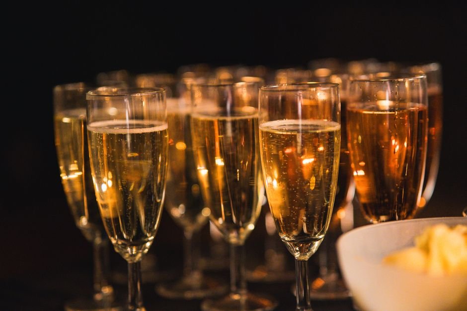 Champagne glasses raised in celebration, a fitting toast for gifts for newlyweds