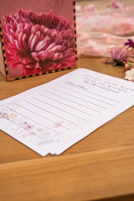Floral baby shower card and note set on a wooden table