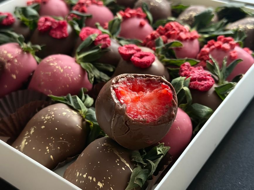 Close-up of chocolate covered strawberries arranged in a gift box for delivery