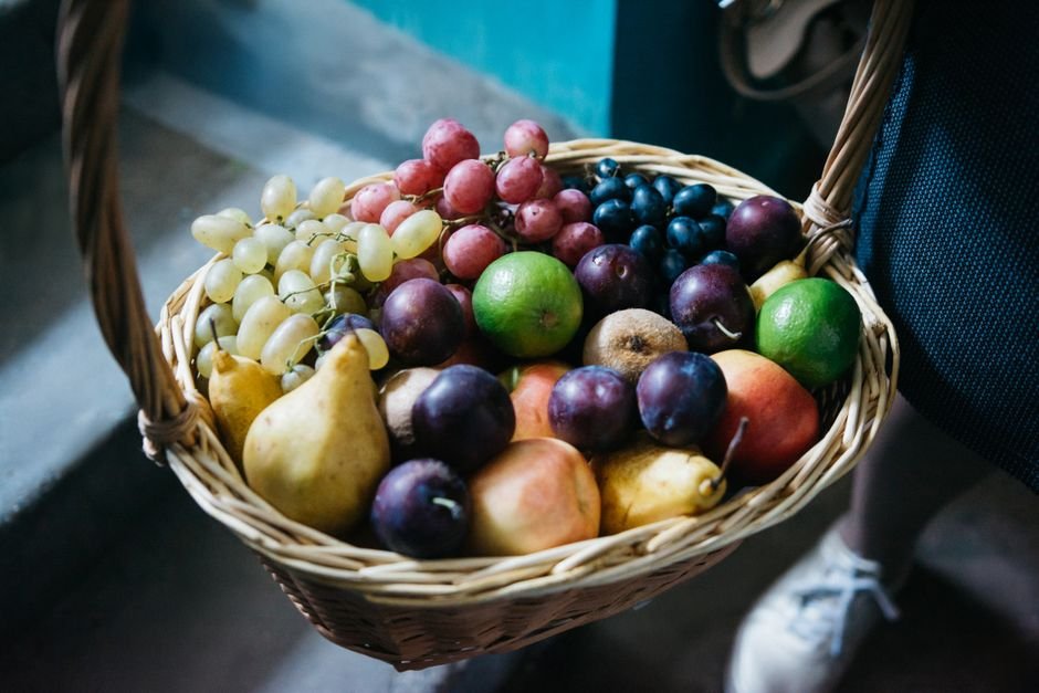 Wicker basket filled with organic fresh fruit