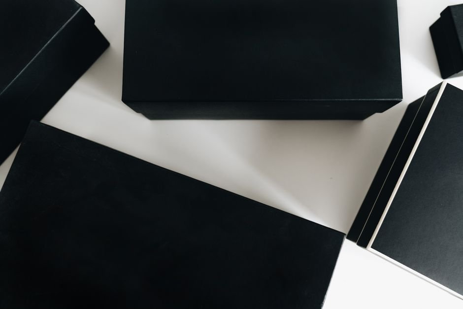 Sleek black gift boxes arranged on a minimalist surface