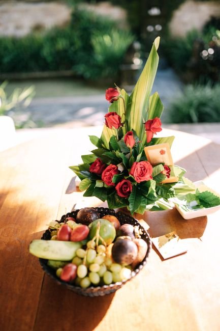 Sympathy fruit basket with a red floral centerpiece