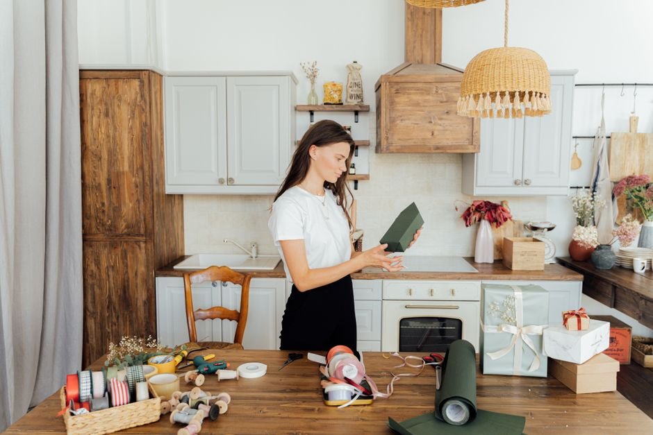 A woman wrapping a kitchen present in a stylish home kitchen