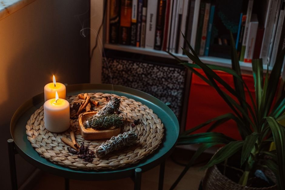 Lit scented candles on a tray at home
