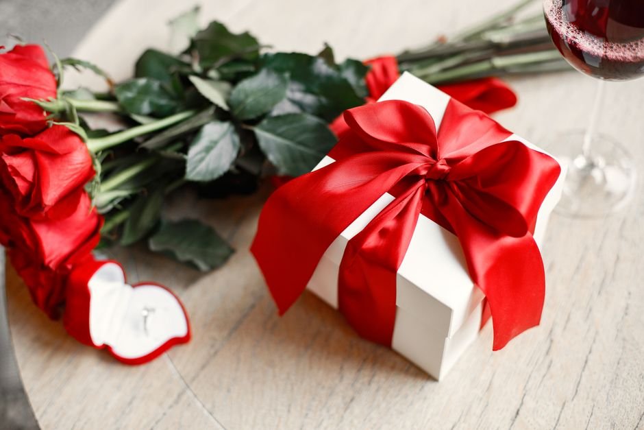 A wrapped gift box with roses, the kind of presentation used in a bridesmaid proposal box