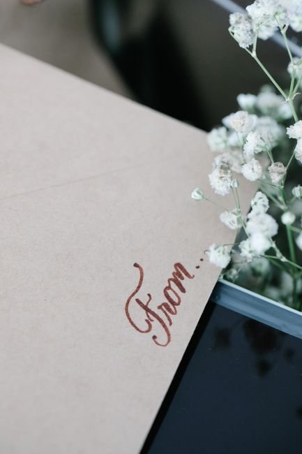 Envelope reading From beside white flowers for a baby shower card