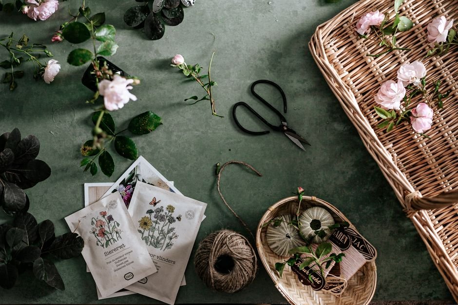 Seed packets, scissors, and roses arranged for a gardener gift basket